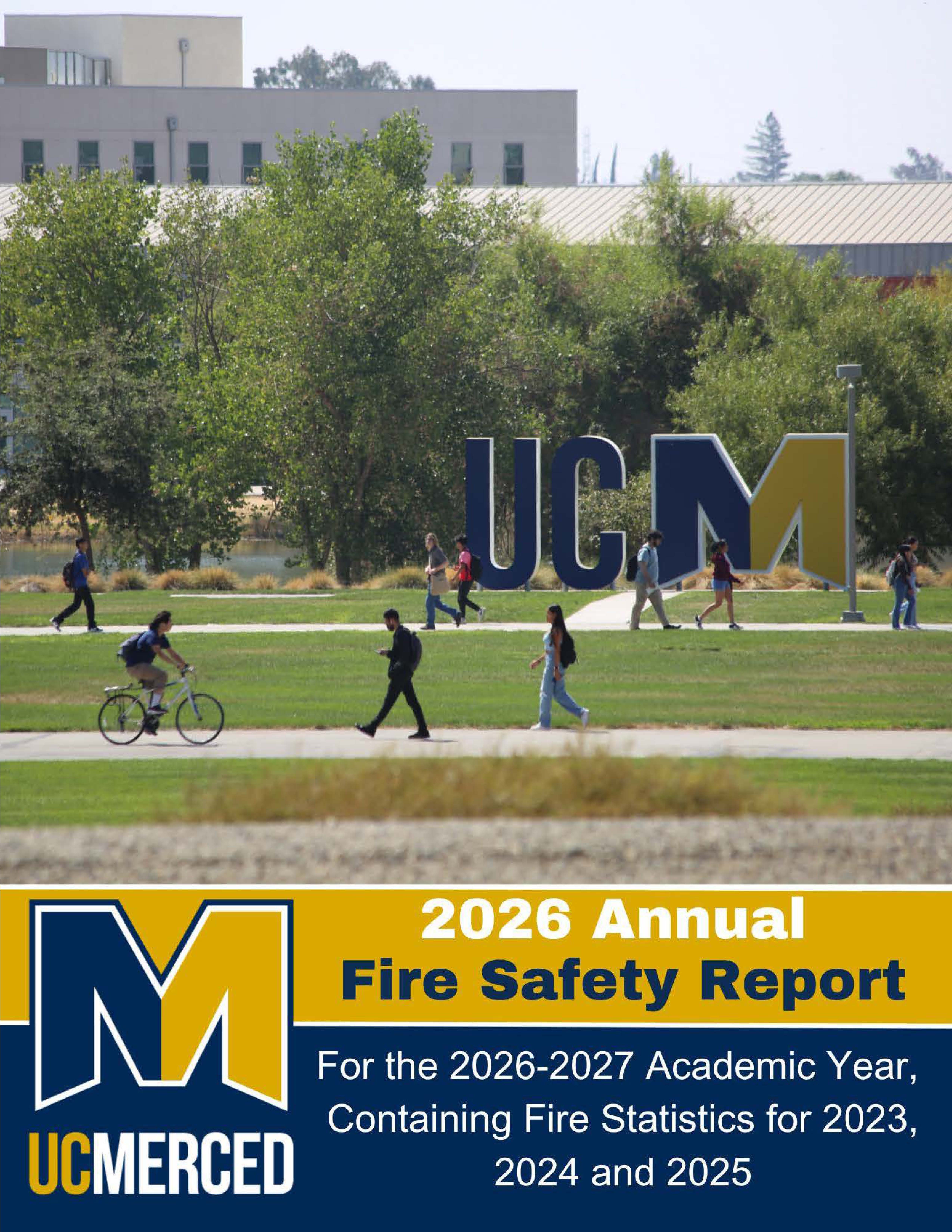 Photo of students walk across campus with the large UCM letters showing in the background